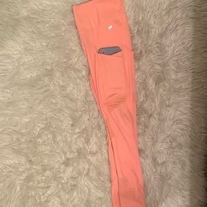 Pink leggings with 2 pockets on each side.